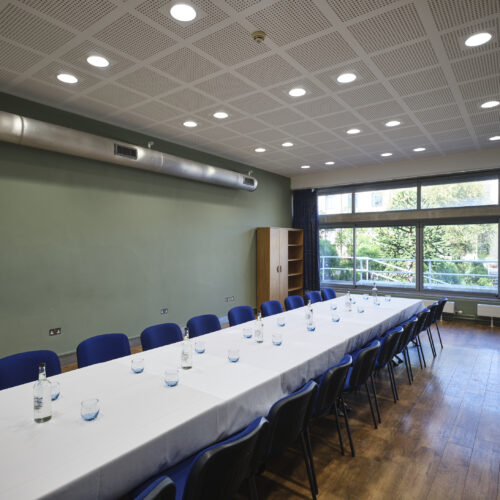 JCR meeting room space at Christ's College, Cambridge set up in a boardroom style with view of the window. A versatile boardroom space in cambridge