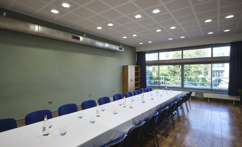 JCR meeting room space at Christ's College, Cambridge set up in a boardroom style with view of the window. A versatile boardroom space in cambridge