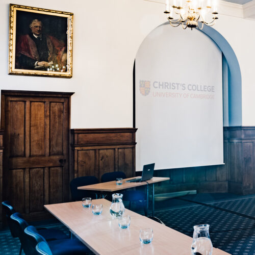 The Lloyd Room at Christ’s College, Cambridge, with high ceilings, large windows, natural daylight, and flexible seating arranged for a meeting or seminar.