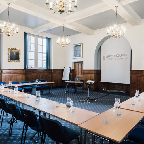 The Lloyd Room at Christ’s College, Cambridge, with high ceilings, large windows, natural daylight, and flexible seating arranged for a meeting or seminar.