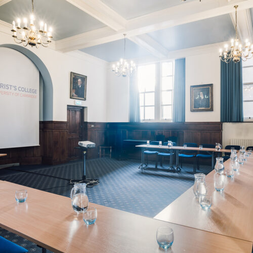 The Lloyd Room at Christ’s College, Cambridge, with high ceilings, large windows, natural daylight, and flexible seating arranged for a meeting or seminar.