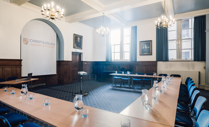 The Lloyd Room at Christ’s College, Cambridge, with high ceilings, large windows, natural daylight, and flexible seating arranged for a meeting or seminar.