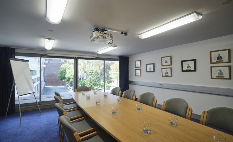 New Court Seminar Room at Christ's College set up for a boardroom meeting. Ideal for small business meetings and interviews.
