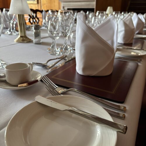 Christ's College cutlery, plate and napkin set up for dinner.