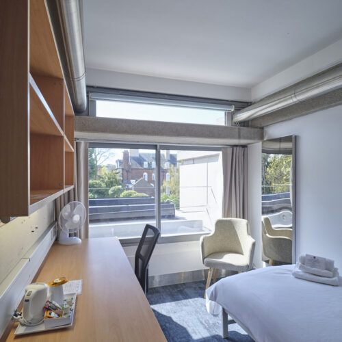 Single guest bedroom at Christ's College Cambridge featuring a comfortable single bed, study desk, storage space, and traditional college surroundings.