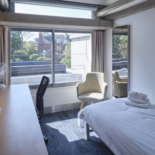 Conference accommodation in Cambridge. An image of a single bed and breakfast room at Christ's College, Cambridge which includes a bed, desk, chair, and tea and coffee making facilities.