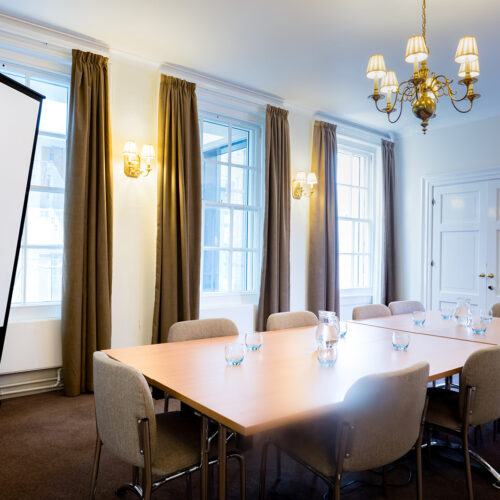 The Sosnow Room at Christ’s College, Cambridge, featuring a light and spacious interior arranged for a small meeting, breakout session, or conference refreshment area.