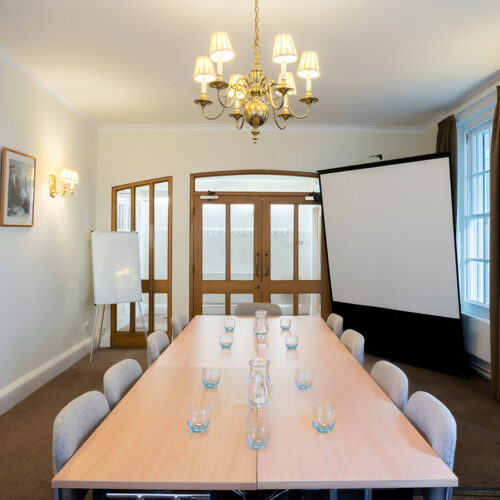 The Sosnow Room at Christ’s College, Cambridge, featuring a light and spacious interior arranged for a small meeting, breakout session, or conference refreshment area.