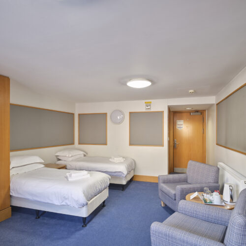 Twin en-suite guest room at Christ's College Cambridge with a comfortable bed, study area, and convenient amenities for Bed & Breakfast guests.